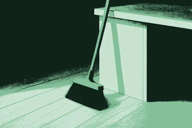 A quiet, freshly swept wooden office floor at the end of the day. A single wide broom leans against the side of a desk, and the floor is clean and bare except for one small neat pile of coins gathered against the baseboard, saved rather than lost, suggesting the calm after-state of cleaning up the mess around the work.